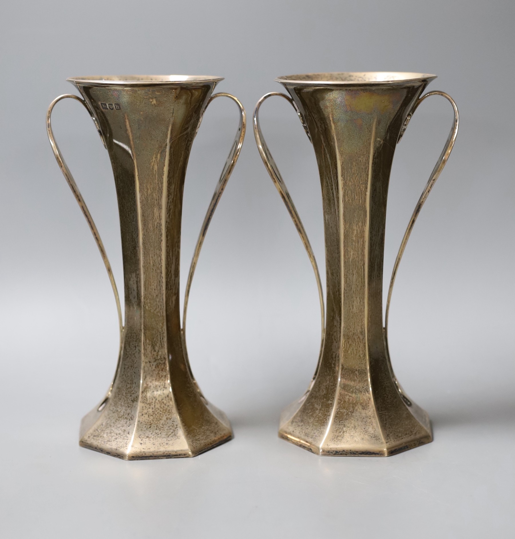 A pair of Edwardian Art Nouveau silver two handled vases, by Goldsmiths & Silversmiths Co Ltd, London, 1903, height 20.7cm, gross 22.2 oz.